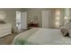 This bedroom features light green walls and a peek into an airy kitchen at 433 Linsbury Ct, Gastonia, NC 28056