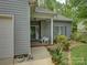 Cozy front porch featuring a seating area and manicured landscaping, creating a charming entrance to the home at 433 Linsbury Ct, Gastonia, NC 28056