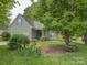 Charming home with a well-maintained lawn, colorful flowers, and mature trees creating a welcoming curb appeal at 433 Linsbury Ct, Gastonia, NC 28056