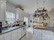 Open concept kitchen featuring a pot rack, white cabinetry, and natural light at 433 Linsbury Ct, Gastonia, NC 28056