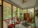 Inviting sunroom with comfortable seating and views of the lush outdoor garden area at 433 Linsbury Ct, Gastonia, NC 28056