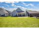A spacious backyard with a well-maintained lawn, patio, and pergola at 5112 Larewood Dr, Charlotte, NC 28215