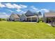 A spacious backyard with a well-maintained lawn, patio, and a covered porch at 5112 Larewood Dr, Charlotte, NC 28215