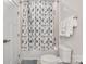 Tiled shower-tub combination with patterned shower curtain and neatly arranged white towels at 5112 Larewood Dr, Charlotte, NC 28215