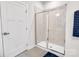Bright bathroom featuring a glass enclosed walk-in shower and a white door at 5112 Larewood Dr, Charlotte, NC 28215