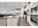 Bright, open kitchen featuring white cabinets, granite countertops, and a large central island with seating at 5112 Larewood Dr, Charlotte, NC 28215