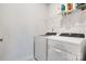 Functional laundry room with a Whirlpool washer and dryer set, wire shelving and white walls at 5112 Larewood Dr, Charlotte, NC 28215