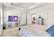 Bright main bedroom featuring two closets, tray ceiling, a TV and views into the kitchen at 5112 Larewood Dr, Charlotte, NC 28215
