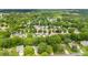 A neighborhood from above with lush green trees and rooftops of many houses at 540 Garrison Sw Ct, Concord, NC 28025