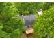 Aerial view of backyard with a wood deck surrounded by lush green trees at 540 Garrison Sw Ct, Concord, NC 28025