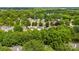 An aerial view of a neighborhood, showcasing the abundance of mature trees and rooftops at 540 Garrison Sw Ct, Concord, NC 28025