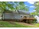 Backyard featuring a wood deck and view of gray siding on the home at 540 Garrison Sw Ct, Concord, NC 28025