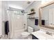 Bathroom featuring a shower-tub combo, storage shelving and modern fixtures at 540 Garrison Sw Ct, Concord, NC 28025