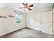 Bright bedroom featuring neutral walls, a ceiling fan, window, two closets and carpeted floor at 540 Garrison Sw Ct, Concord, NC 28025