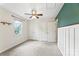 Bedroom with neutral carpet, closets, and contrasting green accent wall at 540 Garrison Sw Ct, Concord, NC 28025