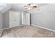 Bright bedroom featuring neutral walls, a ceiling fan, closets, and carpeted floor at 540 Garrison Sw Ct, Concord, NC 28025