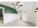 Bedroom with neutral carpet, ceiling fan, and contrasting green accent wall at 540 Garrison Sw Ct, Concord, NC 28025