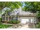 Gray exterior elevation featuring a two-car garage and meticulous landscaping at 540 Garrison Sw Ct, Concord, NC 28025