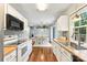 Bright kitchen with wooden countertops, white cabinets and hardwood flooring, open to the dining area at 540 Garrison Sw Ct, Concord, NC 28025