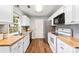 Updated kitchen features stainless appliances, wood countertops, white cabinetry and hard wood floors at 540 Garrison Sw Ct, Concord, NC 28025