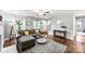 Living room with hardwood floors, neutral paint, and a comfortable gray sectional at 540 Garrison Sw Ct, Concord, NC 28025