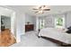 Sunlit main bedroom with soft carpet, ceiling fan, and dresser storage at 540 Garrison Sw Ct, Concord, NC 28025