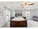 Light-filled bedroom features plush carpeting, a ceiling fan and ample natural light through large windows at 540 Garrison Sw Ct, Concord, NC 28025