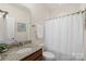 Bathroom with granite vanity top, white shower curtain and hardware at 5422 Shannon Bell Ln, Charlotte, NC 28277
