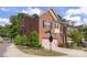 Street-level view of brick townhomes with garages and landscaping at 5422 Shannon Bell Ln, Charlotte, NC 28277