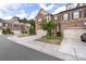 Street scene featuring brick townhomes with garages, greenery, and a stop sign at 5422 Shannon Bell Ln, Charlotte, NC 28277