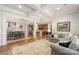 Spacious open-concept living room flows into the dining area and kitchen with beautiful hardwood floors and coffered ceilings at 5422 Shannon Bell Ln, Charlotte, NC 28277