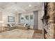 Inviting living room featuring a stone fireplace, large windows, and comfortable sectional sofa at 5422 Shannon Bell Ln, Charlotte, NC 28277