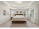 Bright main bedroom with a tray ceiling, and multiple windows with coverings at 5422 Shannon Bell Ln, Charlotte, NC 28277