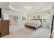 Large main bedroom with tray ceiling, access to main bathroom, and an attached sitting area at 5422 Shannon Bell Ln, Charlotte, NC 28277