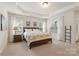Relaxing main bedroom suite with tray ceilings, lots of natural light, and carpeted floors at 5422 Shannon Bell Ln, Charlotte, NC 28277