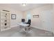 Home office featuring a white desk, carpet and built in shelving at 5422 Shannon Bell Ln, Charlotte, NC 28277