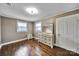 Bedroom featuring hardwood floors, two windows, and a painted wood dresser at 5573 Main St, Fort Lawn, SC 29714