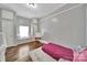 Cozy bedroom with hardwood floors, window seat, and grey wood paneling at 5573 Main St, Fort Lawn, SC 29714