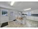 Charming kitchen with tile floors, eat-in island, and laundry appliances at 5573 Main St, Fort Lawn, SC 29714