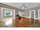 Bright living room with hardwood floors, neutral walls, and a comfortable chair bathed in natural light at 5573 Main St, Fort Lawn, SC 29714