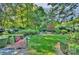 Private backyard featuring lush landscaping and a tranquil seating area at 6005 Bryant Ln, Waxhaw, NC 28173