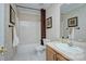 Bathroom with tub, shower, and sink with vanity, featuring a neutral wallpaper and tile floor at 6005 Bryant Ln, Waxhaw, NC 28173