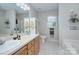 Bright bathroom featuring a double vanity, soaking tub, and large mirror at 6005 Bryant Ln, Waxhaw, NC 28173