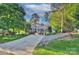 Charming brick home with a well-manicured lawn, mature trees, and an ample driveway at 6005 Bryant Ln, Waxhaw, NC 28173