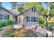 Inviting patio featuring a table with red chairs, well-maintained garden, and charming brick facade at 6005 Bryant Ln, Waxhaw, NC 28173
