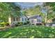 Charming brick home featuring a lush green lawn and mature trees, creating a serene and inviting exterior at 6005 Bryant Ln, Waxhaw, NC 28173