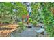 Serene garden featuring a red arbor, stone benches, and meticulously maintained landscaping at 6005 Bryant Ln, Waxhaw, NC 28173