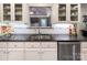 Well-lit kitchen with white cabinets, granite countertops, stainless steel appliances, and a mosaic backsplash at 6005 Bryant Ln, Waxhaw, NC 28173