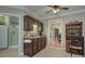 Butler's pantry area offers dark wood cabinets, mosaic backsplash, and convenient sink at 6005 Bryant Ln, Waxhaw, NC 28173