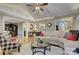 Comfortable living room with hardwood floors, a plush sectional sofa, and a view into the dining area at 6005 Bryant Ln, Waxhaw, NC 28173